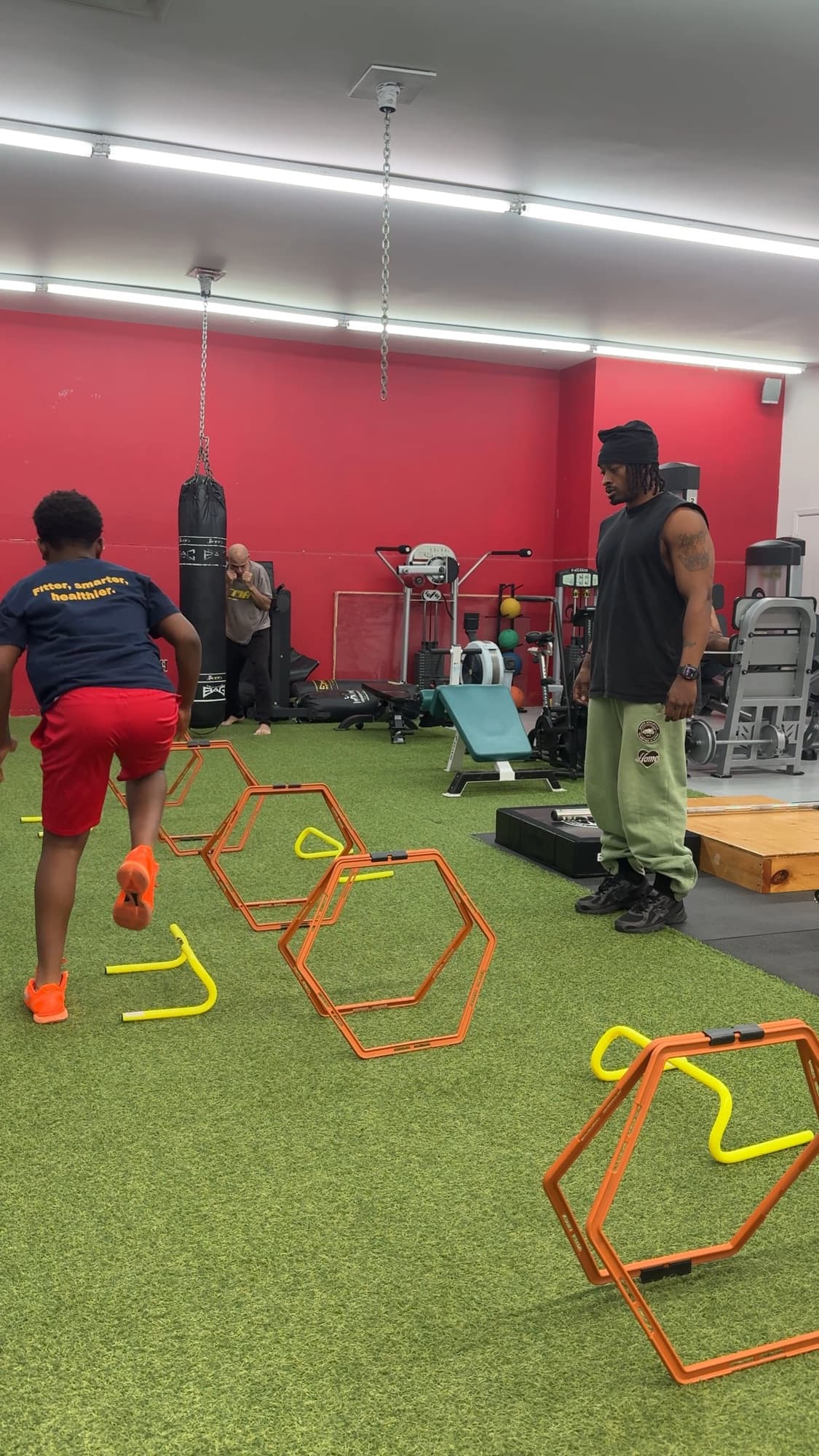 Zu coaching a young athlete through an agility drill